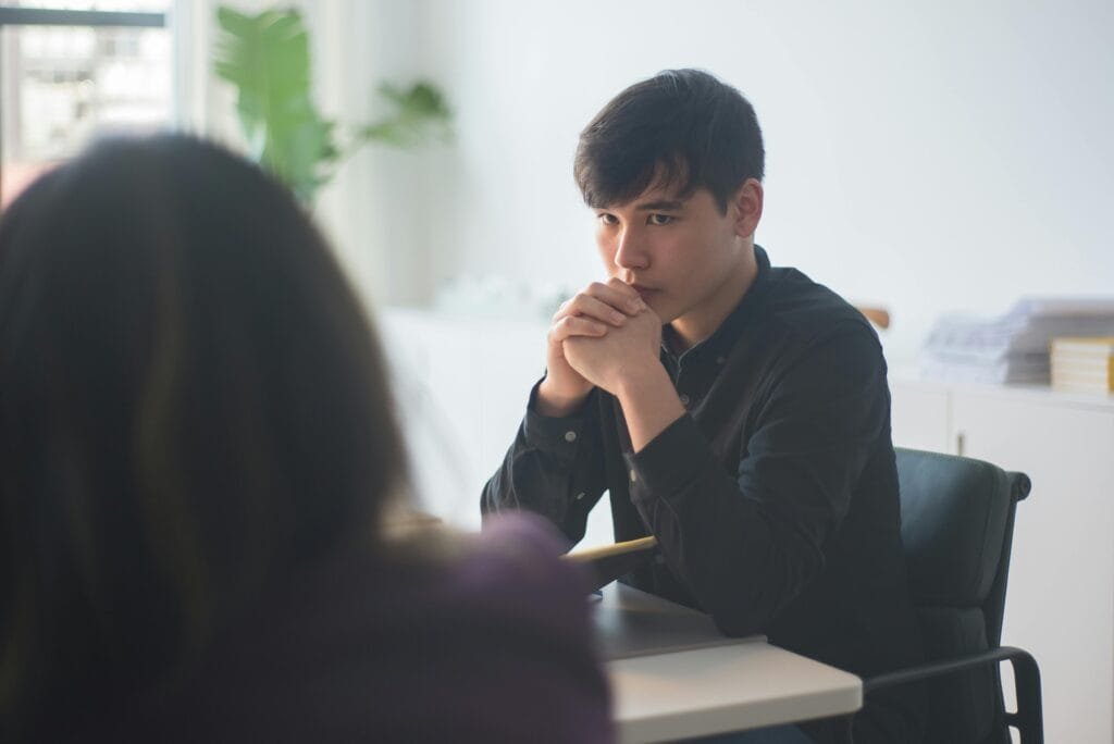 Young professionals engaged in a serious business discussion in a modern office.